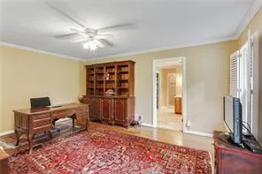 a view of a workspace with furniture and a window