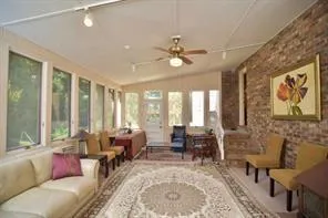 a living room with furniture large windows and a table