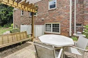 a view of backyard with brick wall