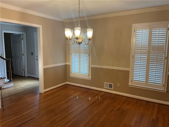 a view of a livingroom with wooden floor and a window
