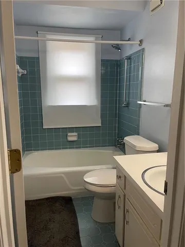 a bathroom with a sink a toilet a mirror and shower