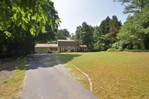 a view of a swimming pool with a yard
