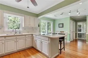 a kitchen with a sink stove and wooden cabinets