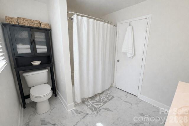 636 Willis Road Dallas, NC 28034 - Photo 14 of 18 a bathroom with a toilet and a shower curtain