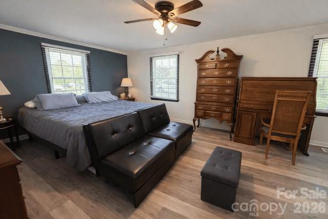 636 Willis Road Dallas, NC 28034 - Photo 10 of 18 a spacious bedroom with a bed a couch and a window