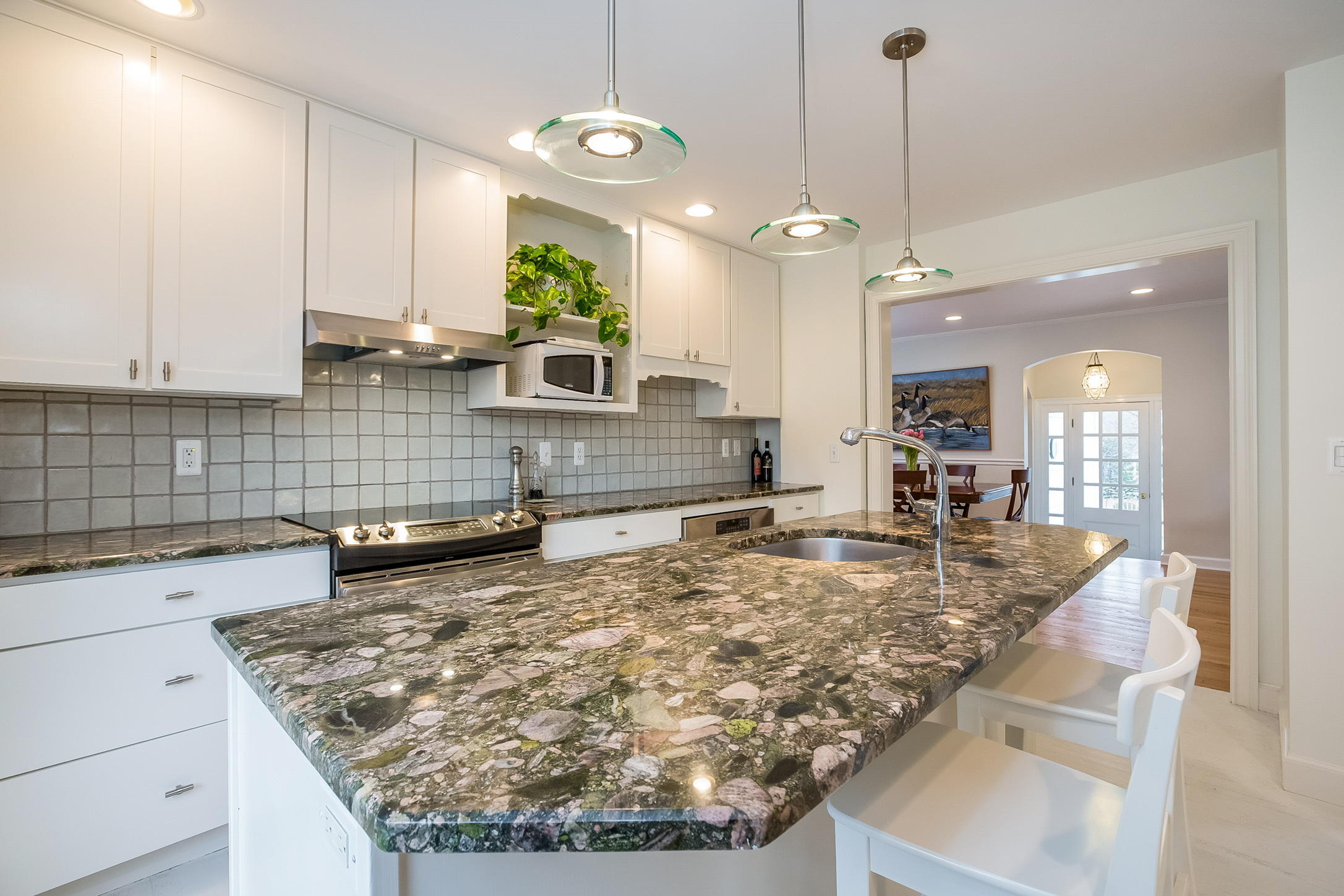 9 Ridgewood Road Rowayton, CT 06853 - Photo 7 of 25 a kitchen with kitchen island granite countertop a sink a center island and stove