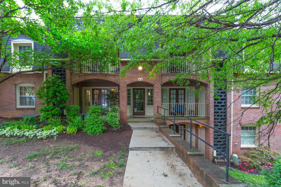 8110 Colony Point Road, Unit K Springfield, VA 22152 - Photo 1 of 30 a front view of a house with a garden