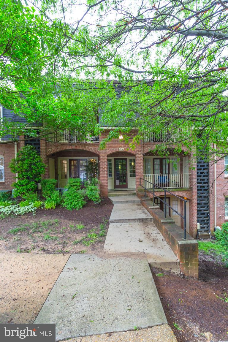 8110 Colony Point Road, Unit K Springfield, VA 22152 - Photo 2 of 30 front view of a house with a yard