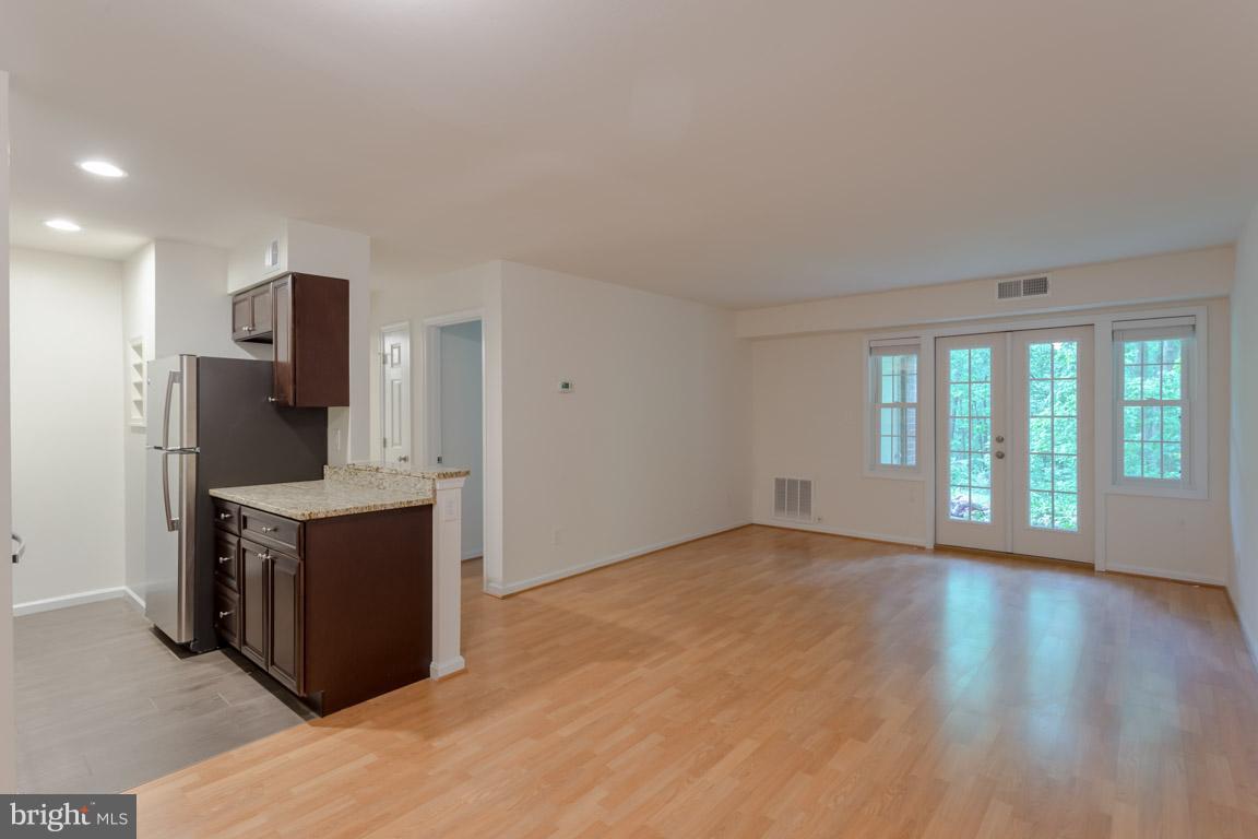 8110 Colony Point Road, Unit K Springfield, VA 22152 - Photo 15 of 30 a kitchen with stainless steel appliances granite countertop a stove and a refrigerator