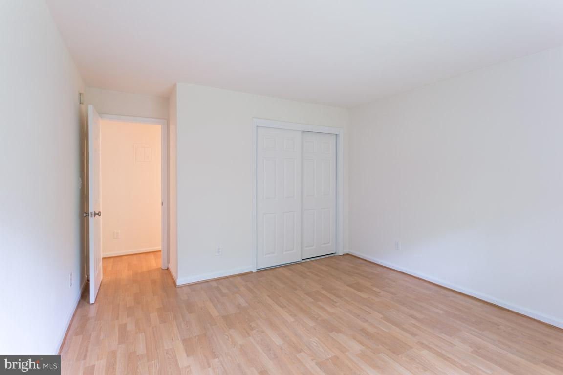 8110 Colony Point Road, Unit K Springfield, VA 22152 - Photo 18 of 30 a view of empty room with wooden floor
