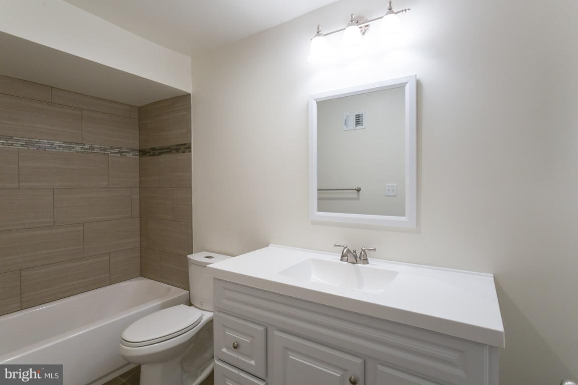 8110 Colony Point Road, Unit K Springfield, VA 22152 - Photo 19 of 30 a bathroom with a sink a toilet and shower