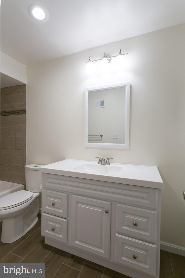 8110 Colony Point Road, Unit K Springfield, VA 22152 - Photo 20 of 30 a bathroom with a toilet sink and mirror