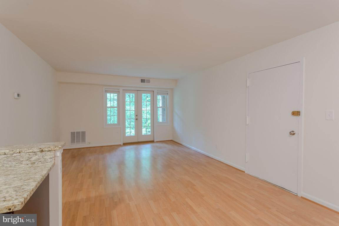 8110 Colony Point Road, Unit K Springfield, VA 22152 - Photo 6 of 30 a view of an empty room with wooden floor and a window