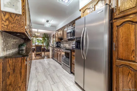 a kitchen with stainless steel appliances granite countertop a refrigerator and a stove