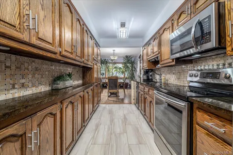 a kitchen with stainless steel appliances granite countertop lots of counter top space