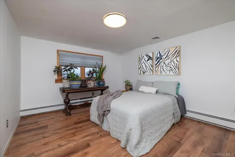 a bedroom with a bed table and window