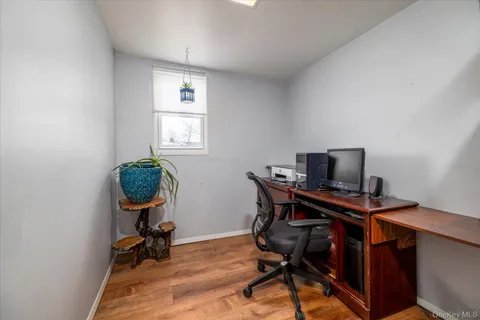 a view of a workspace with furniture and a window
