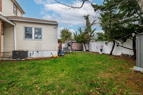 a view of a house with a backyard