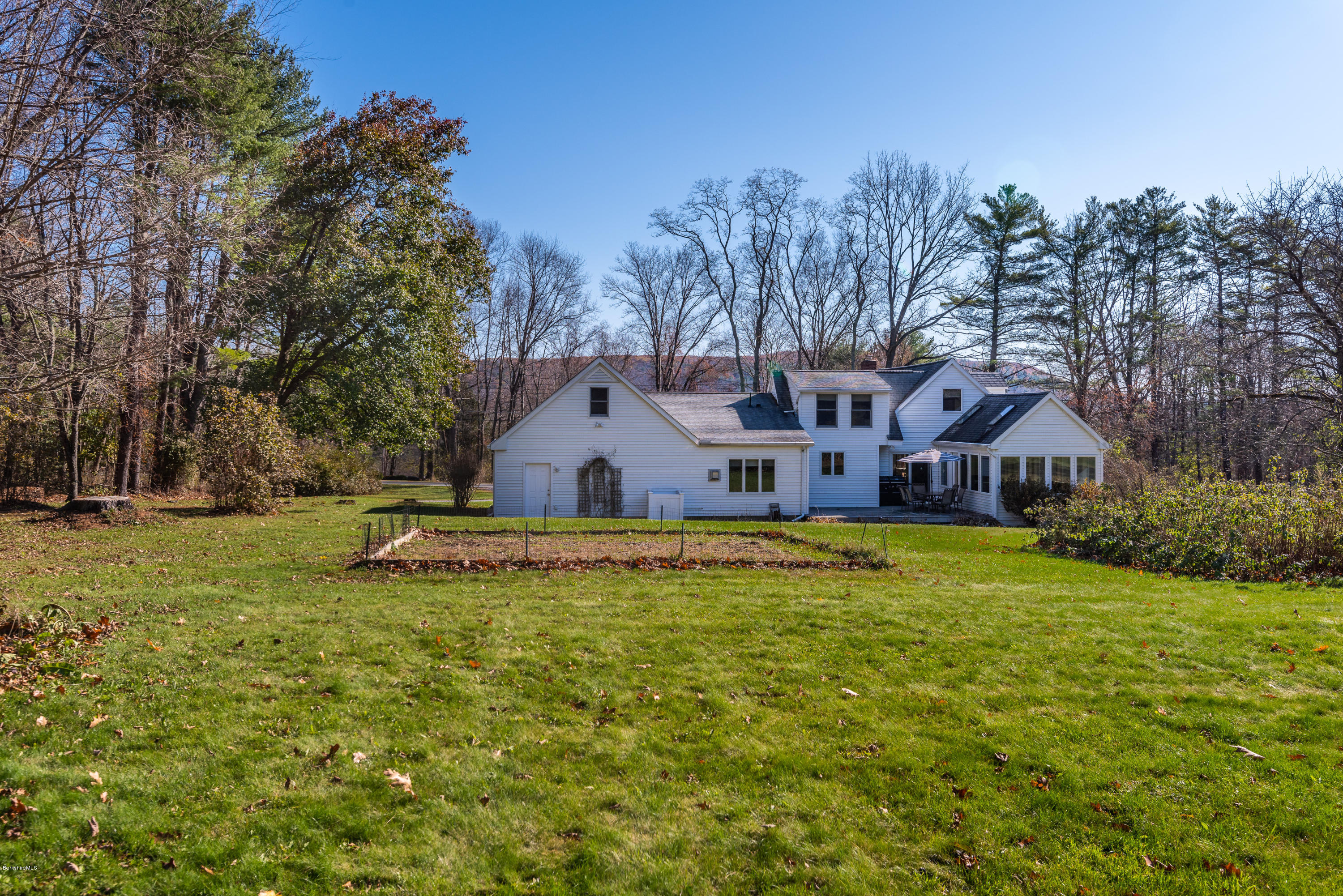 31 Interlaken Road Stockbridge, MA 01266 - Photo 33 of 34 a view of a house with a big yard and large trees