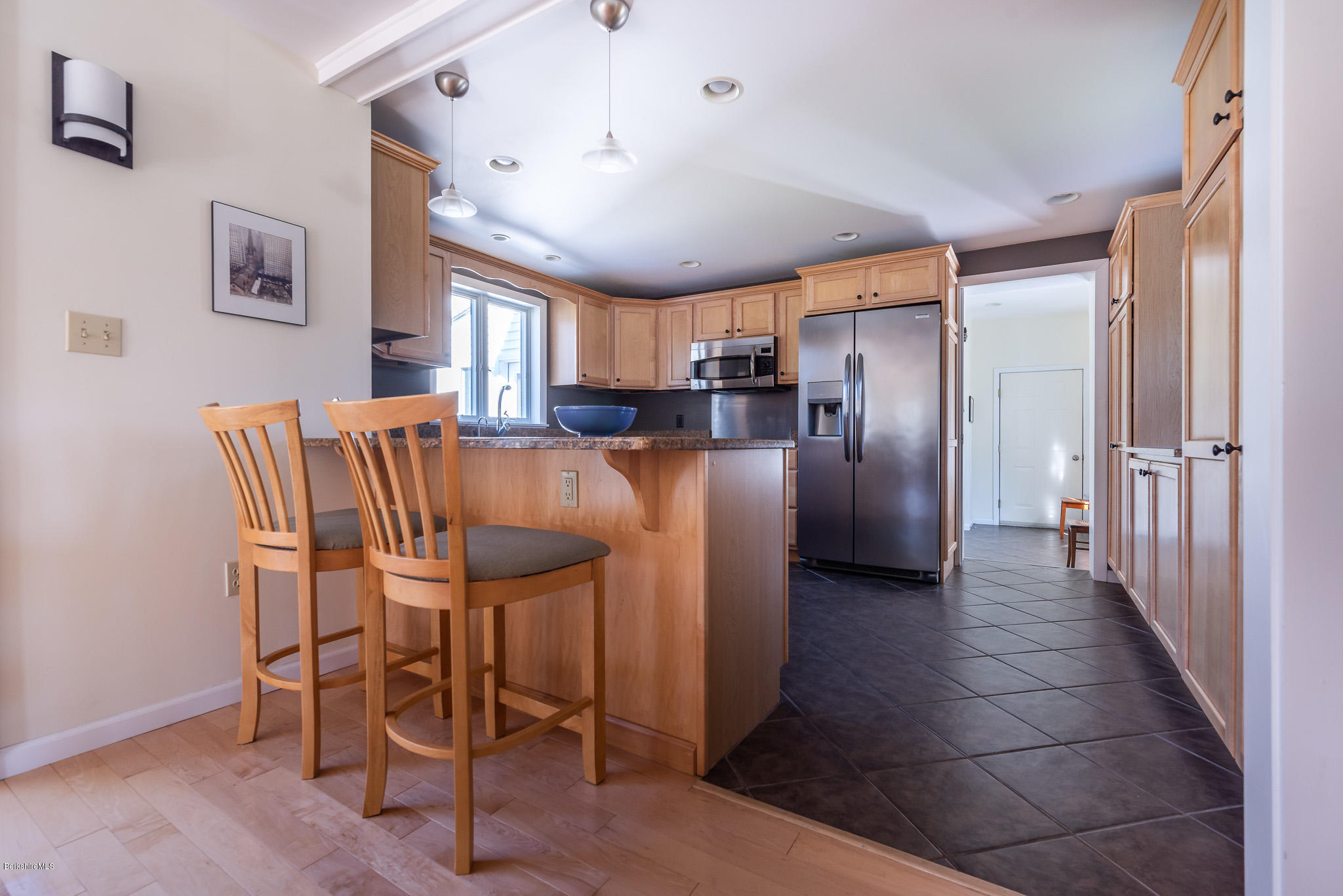31 Interlaken Road Stockbridge, MA 01266 - Photo 6 of 34 a kitchen with stainless steel appliances refrigerator dining table and chairs