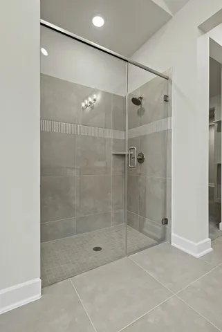 a bathroom that has a glass shower door