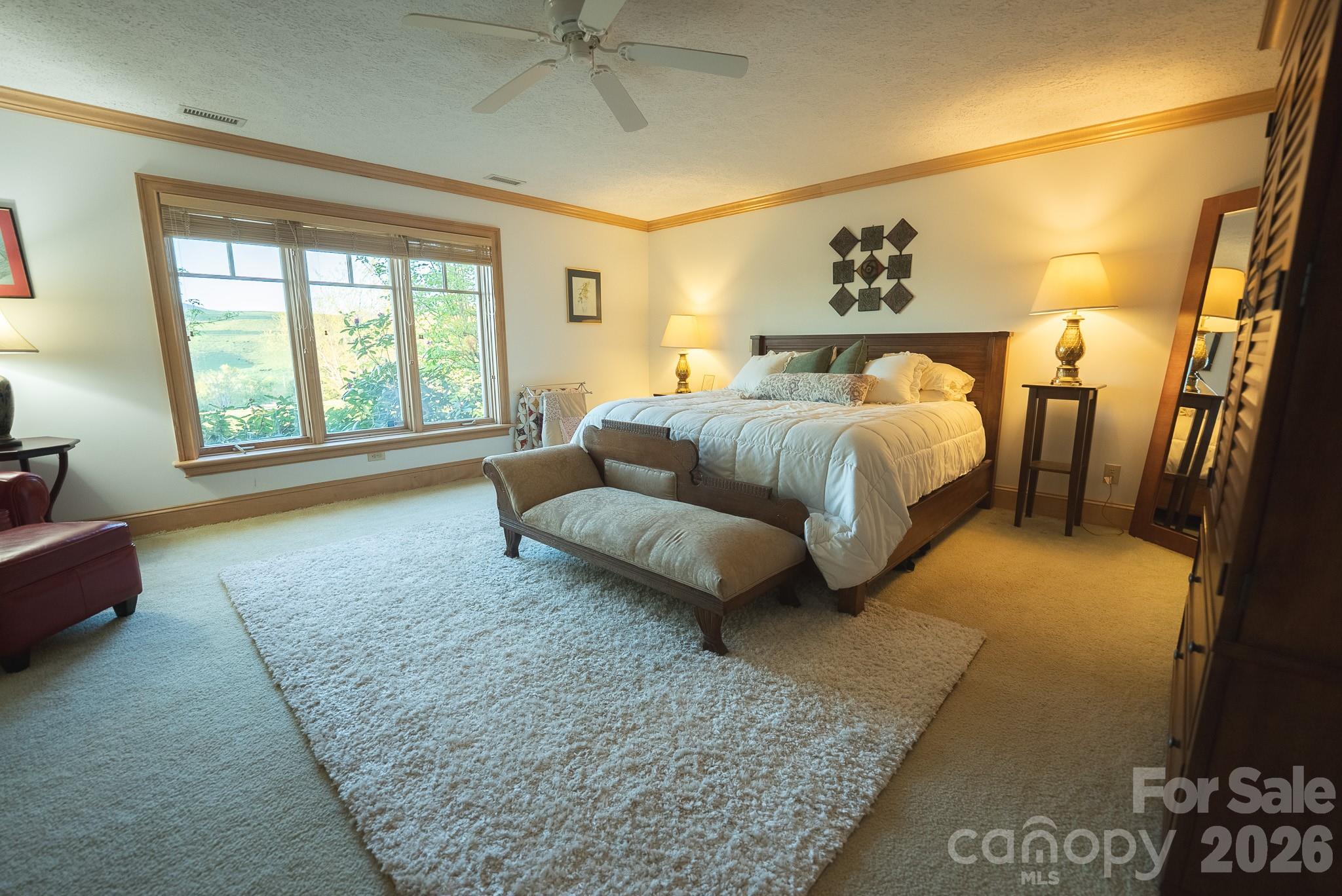6985 Junaluska Road Boone, NC 28607 - Photo 25 of 35 a spacious bedroom with a bed and a couch
