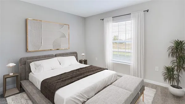 a bedroom with a large bed and a potted plant