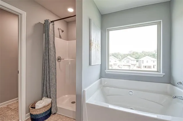 a bathroom with a tub and a shower