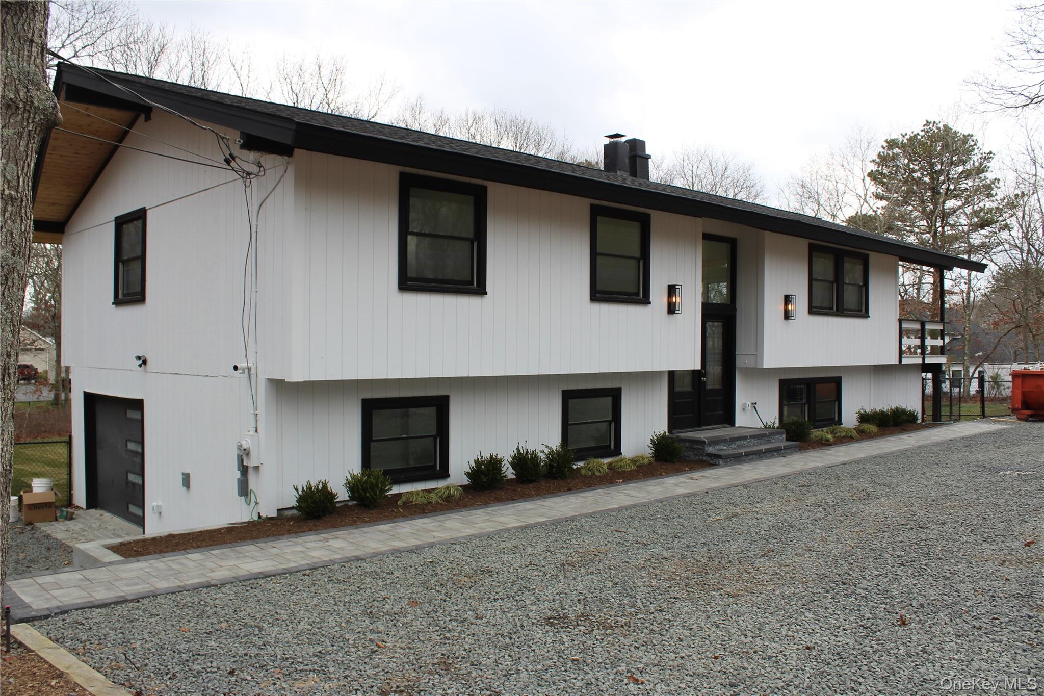 105 Old Riverhead Road Hampton Bays, NY 11946 - Photo 11 of 18 Bi-level home with a chimney and a garage