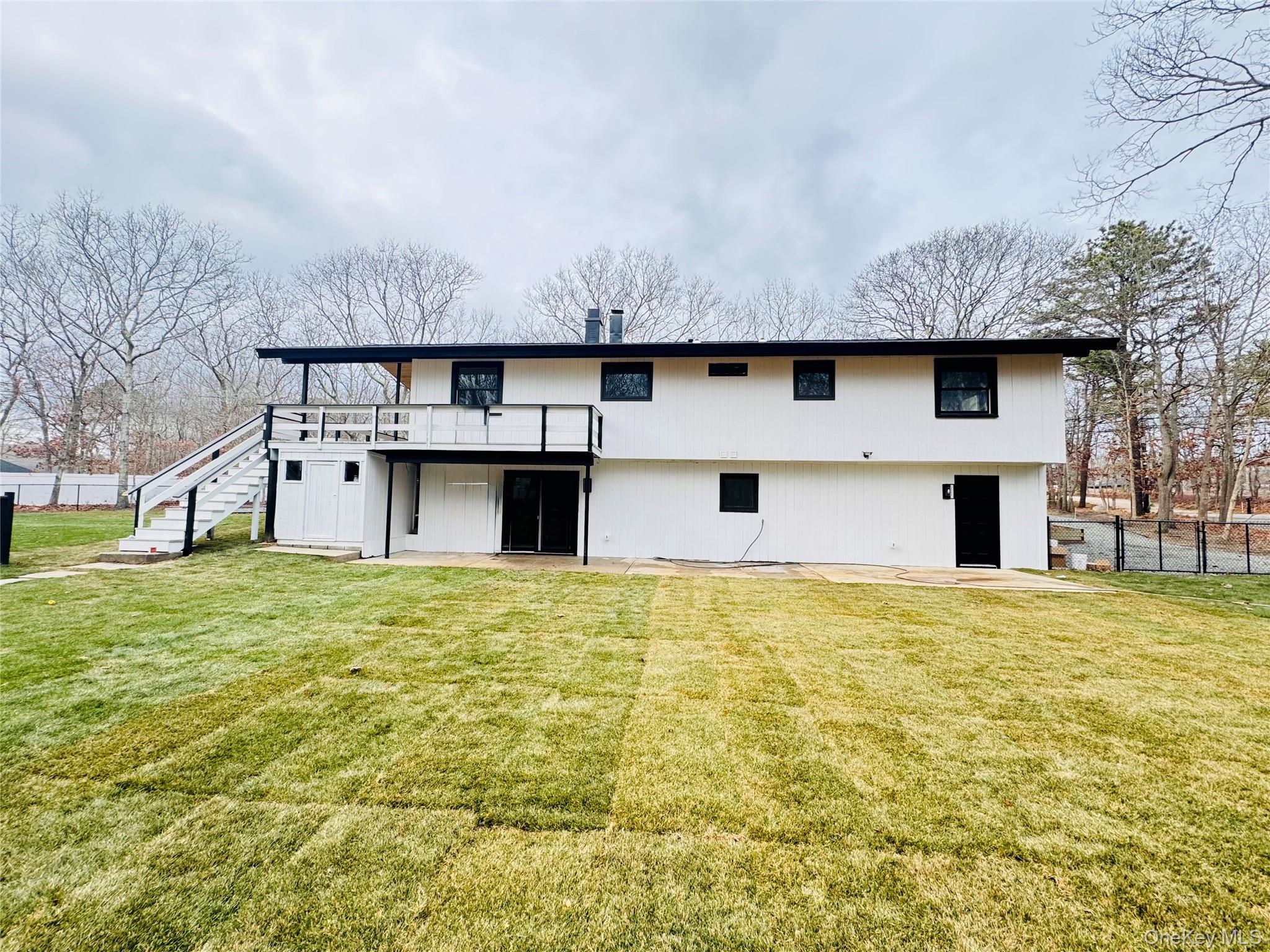 105 Old Riverhead Road Hampton Bays, NY 11946 - Photo 13 of 18 Rear view of property featuring stairs, a patio area, and a wooden deck