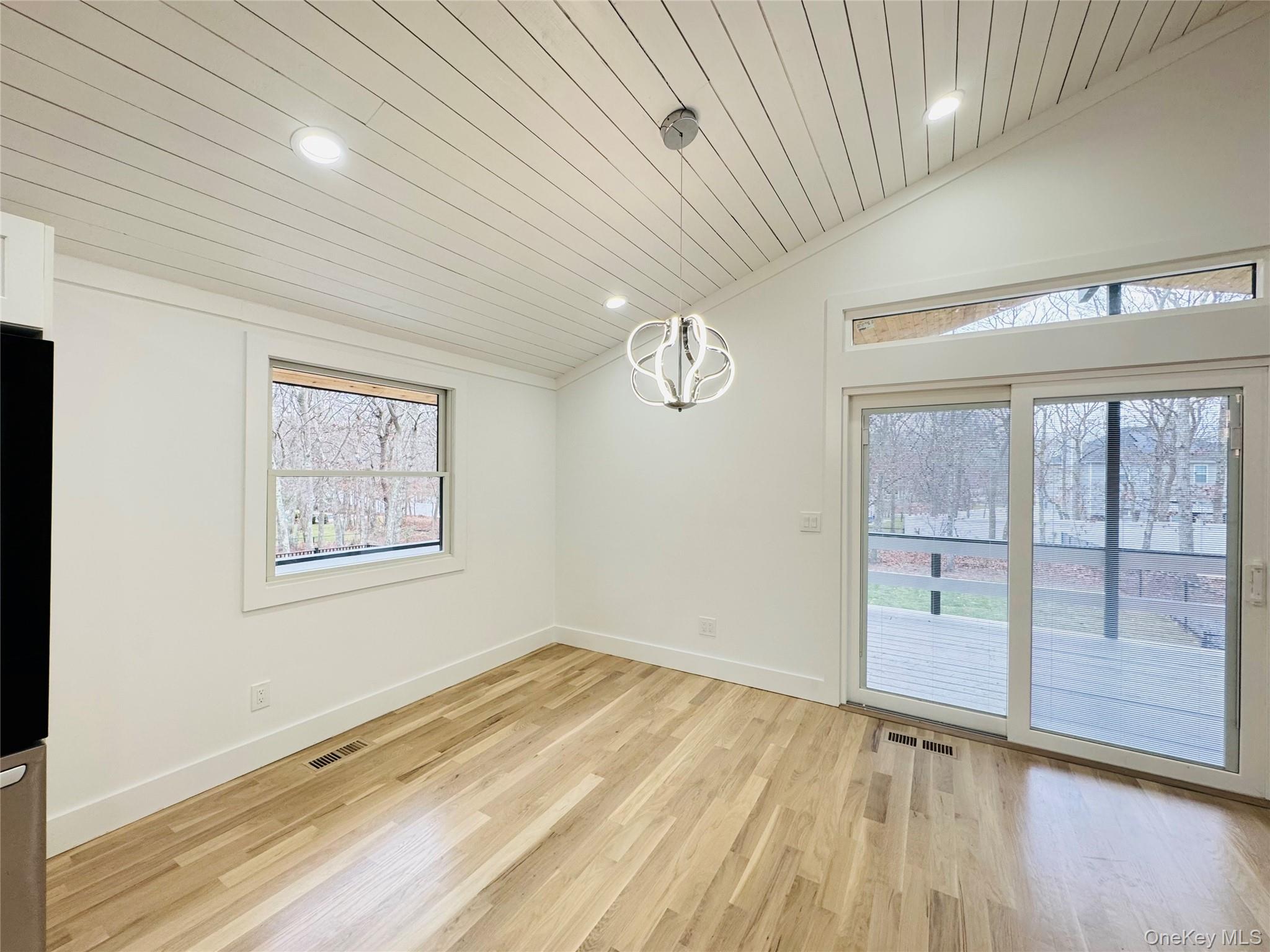105 Old Riverhead Road Hampton Bays, NY 11946 - Photo 7 of 18 Unfurnished dining area with recessed lighting, lofted ceiling, light wood-style floors, and wooden ceiling