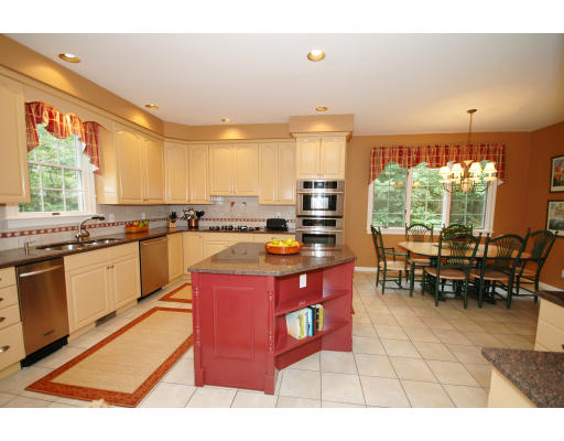 15 Redcoat Road Bedford, MA 01730 - Photo 8 of 27 a kitchen with stainless steel appliances granite countertop a stove a sink and a microwave