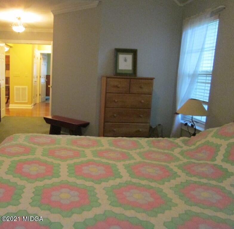 1480 Johnson Road Macon, GA 31220 - Photo 42 of 75 a bedroom with a bed and wooden floor