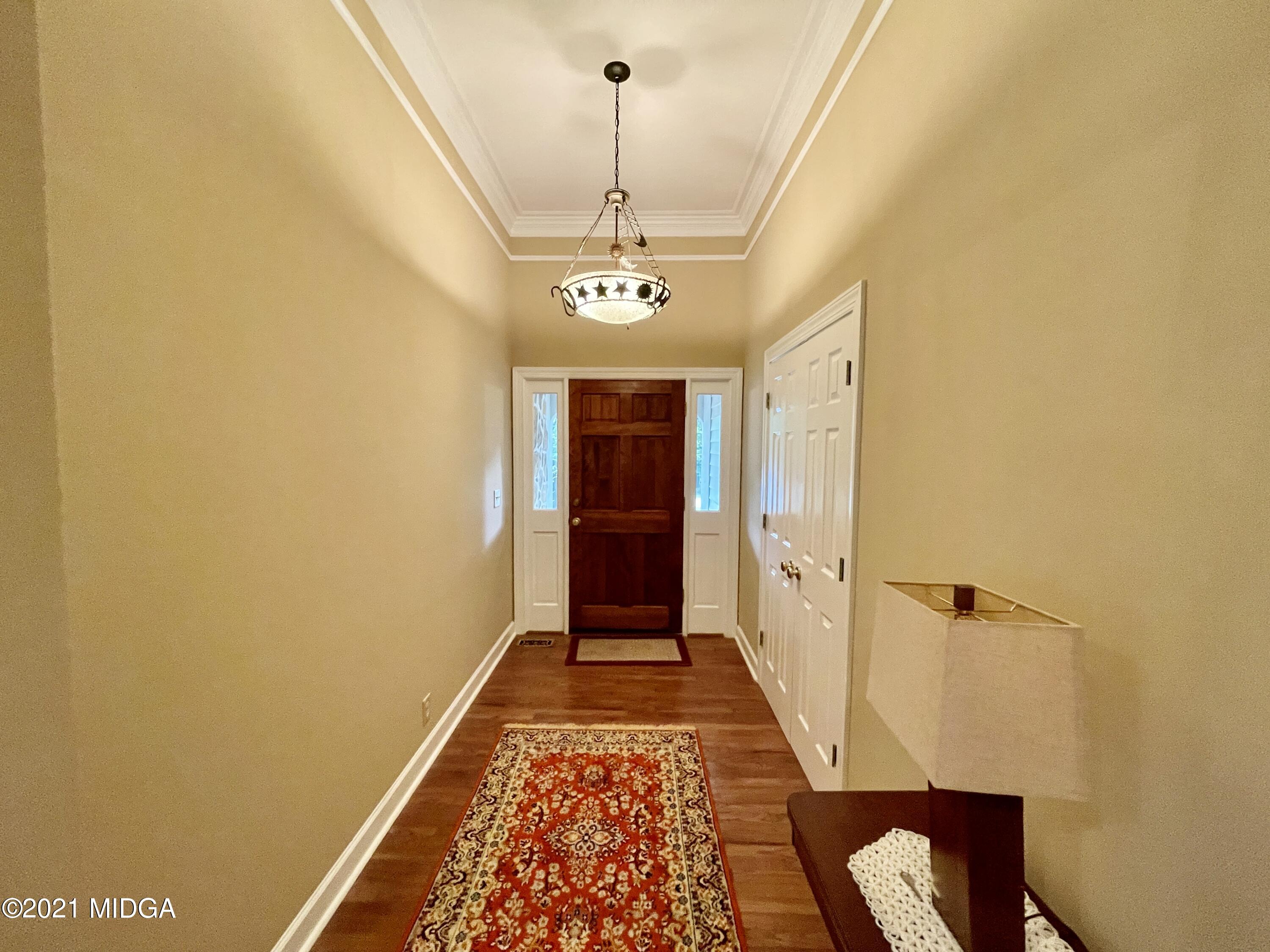 1480 Johnson Road Macon, GA 31220 - Photo 8 of 75 a view of a hallway with wooden floor and a chandelier