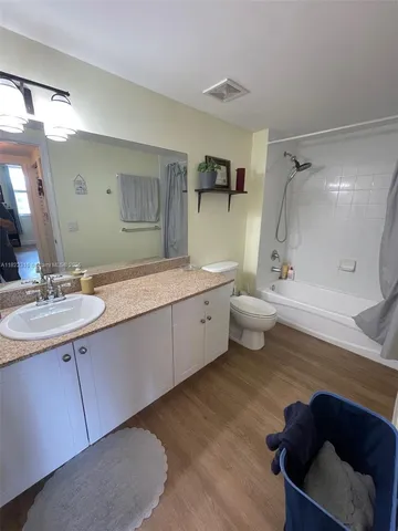 a bathroom with a double vanity sink toilet and shower