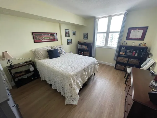 a bedroom with a bed window and a dresser