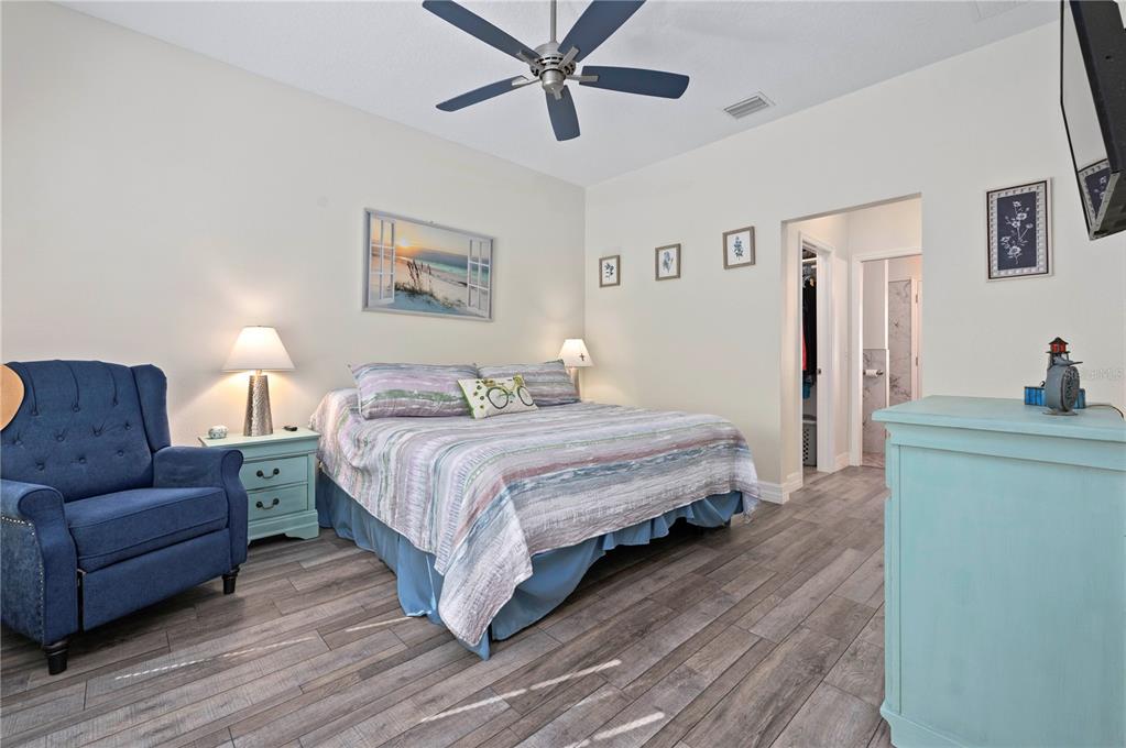 1212 Reynolds Road De Leon Springs, FL 32130 - Photo 14 of 32 a bedroom with a large bed and a couch