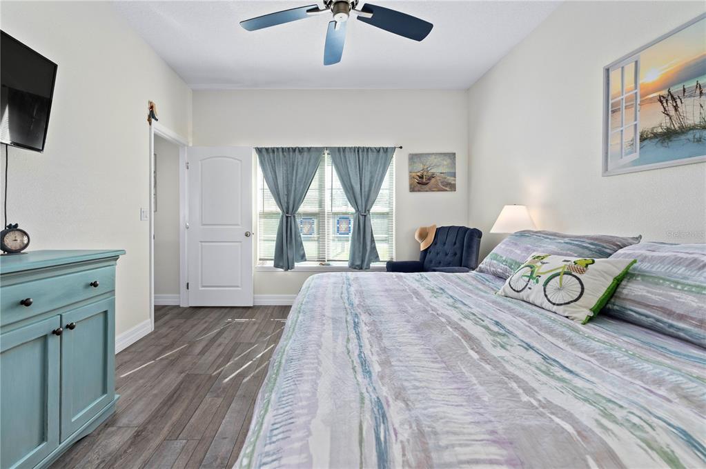 1212 Reynolds Road De Leon Springs, FL 32130 - Photo 15 of 32 a bedroom with a bed and a flat tv screen on dresser