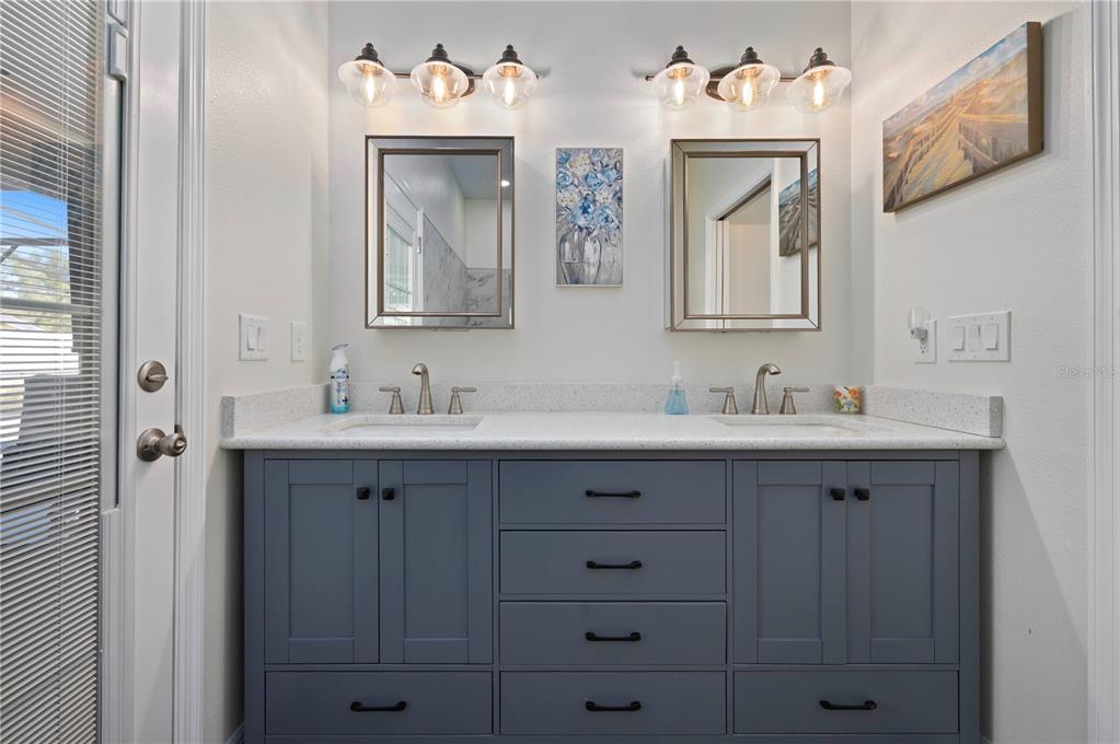 1212 Reynolds Road De Leon Springs, FL 32130 - Photo 17 of 32 a bathroom with a sink vanity and mirror