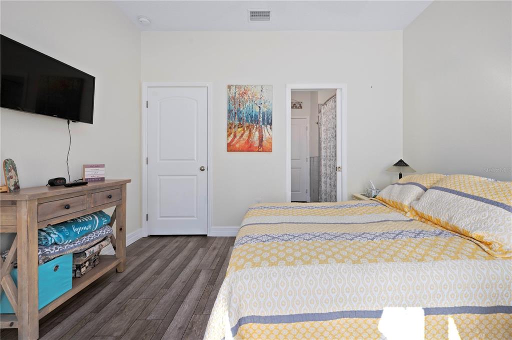 1212 Reynolds Road De Leon Springs, FL 32130 - Photo 24 of 32 a bedroom with a bed and a flat screen tv