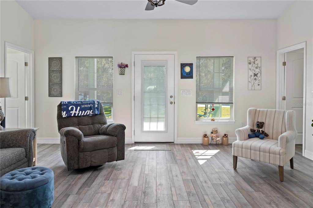 1212 Reynolds Road De Leon Springs, FL 32130 - Photo 6 of 32 a living room with furniture and a large window