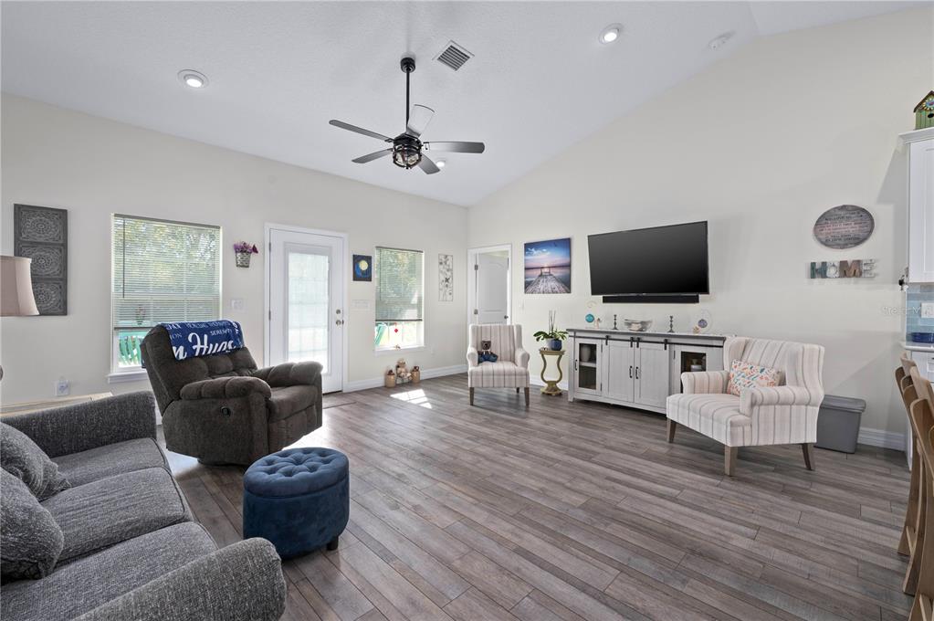 1212 Reynolds Road De Leon Springs, FL 32130 - Photo 7 of 32 a living room with furniture and a flat screen tv