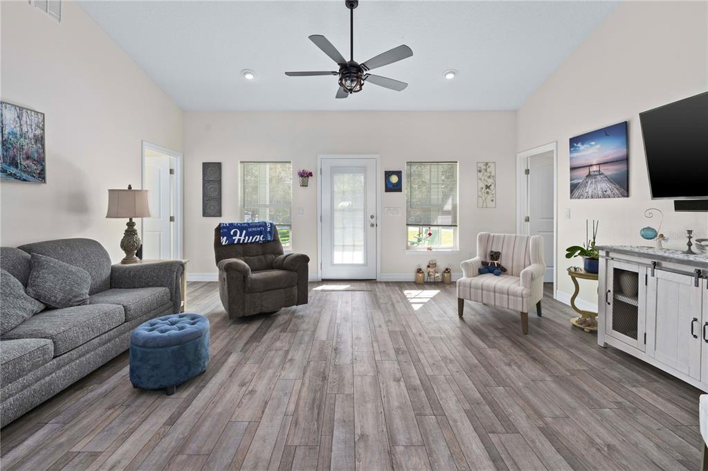 1212 Reynolds Road De Leon Springs, FL 32130 - Photo 8 of 32 a living room with furniture and a flat screen tv