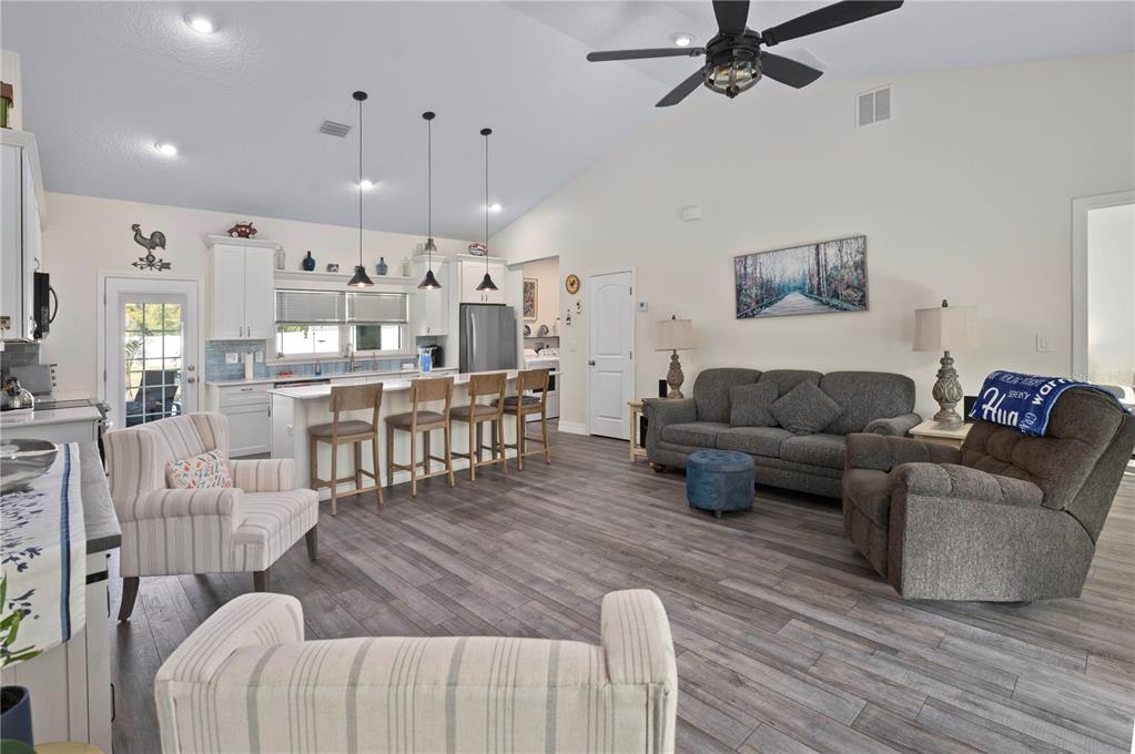 1212 Reynolds Road De Leon Springs, FL 32130 - Photo 9 of 32 a living room with furniture kitchen view and a wooden floor