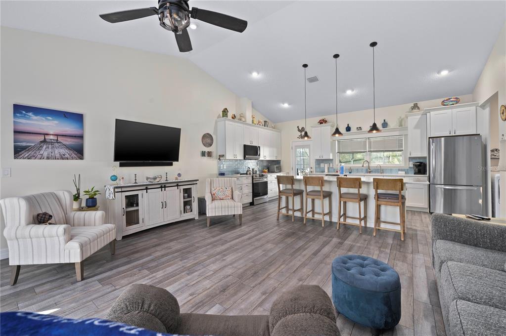 1212 Reynolds Road De Leon Springs, FL 32130 - Photo 10 of 32 a living room with furniture and a flat screen tv