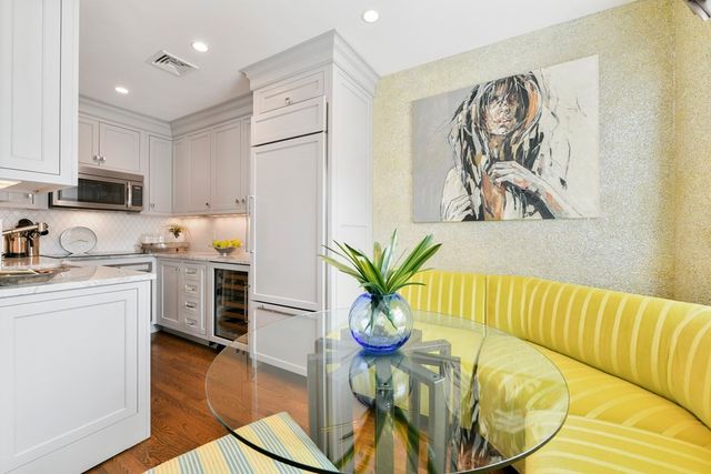 a kitchen with stainless steel appliances a white refrigerator a stove top oven a sink and dishwasher