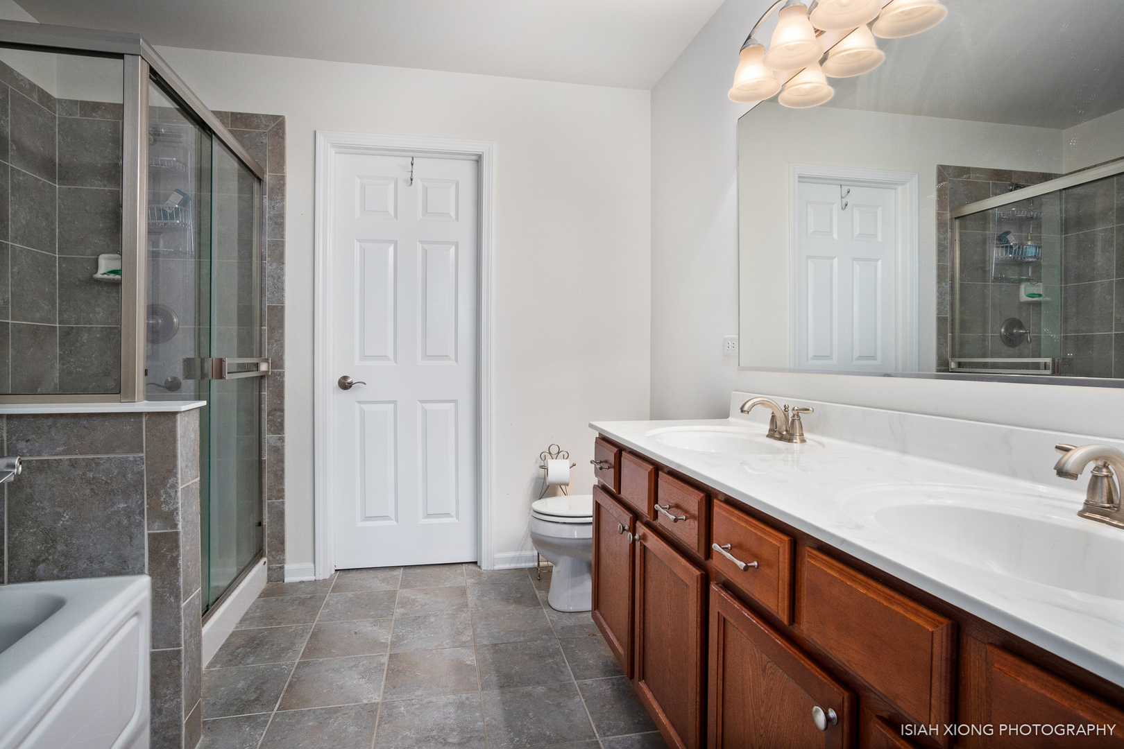 2964 Church Road Aurora, IL 60502 - Photo 11 of 16 a bathroom with a double vanity sink and mirror with shower