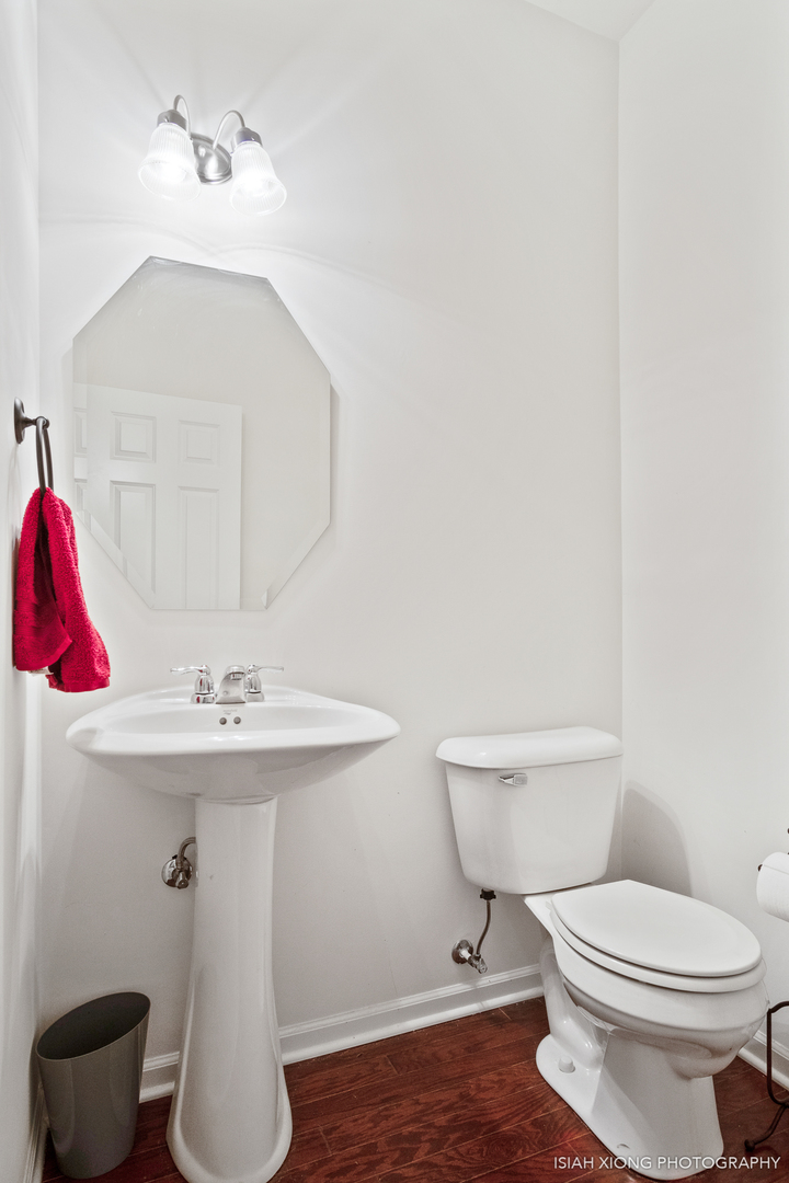 2964 Church Road Aurora, IL 60502 - Photo 7 of 16 a bathroom with a sink a toilet and a mirror