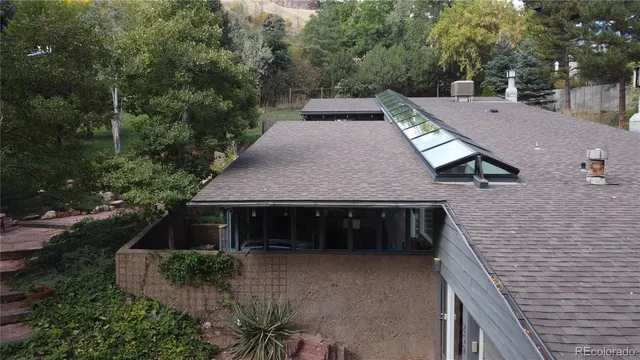 an aerial view of a house with swimming pool and a yard