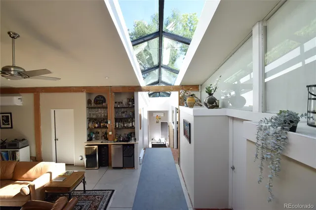 a view of a hallway with dining area window and wooden floor